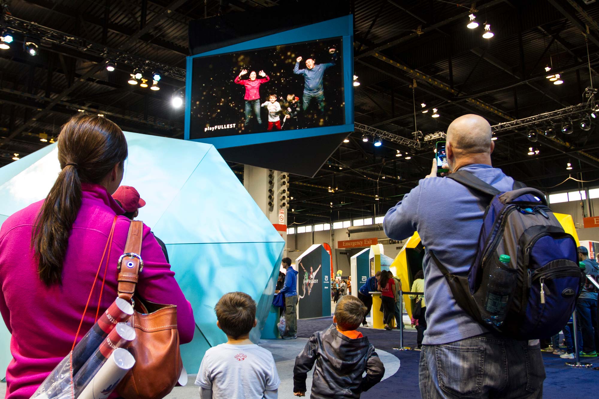 Participants watch themselves on the large overhead screen