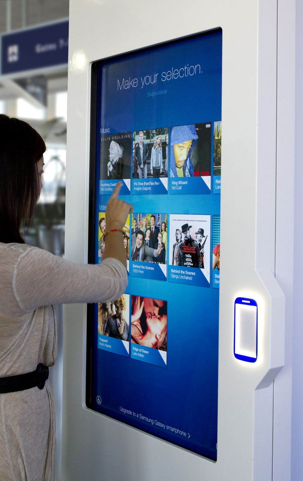User interacting with the Samsung NFC kiosk screen