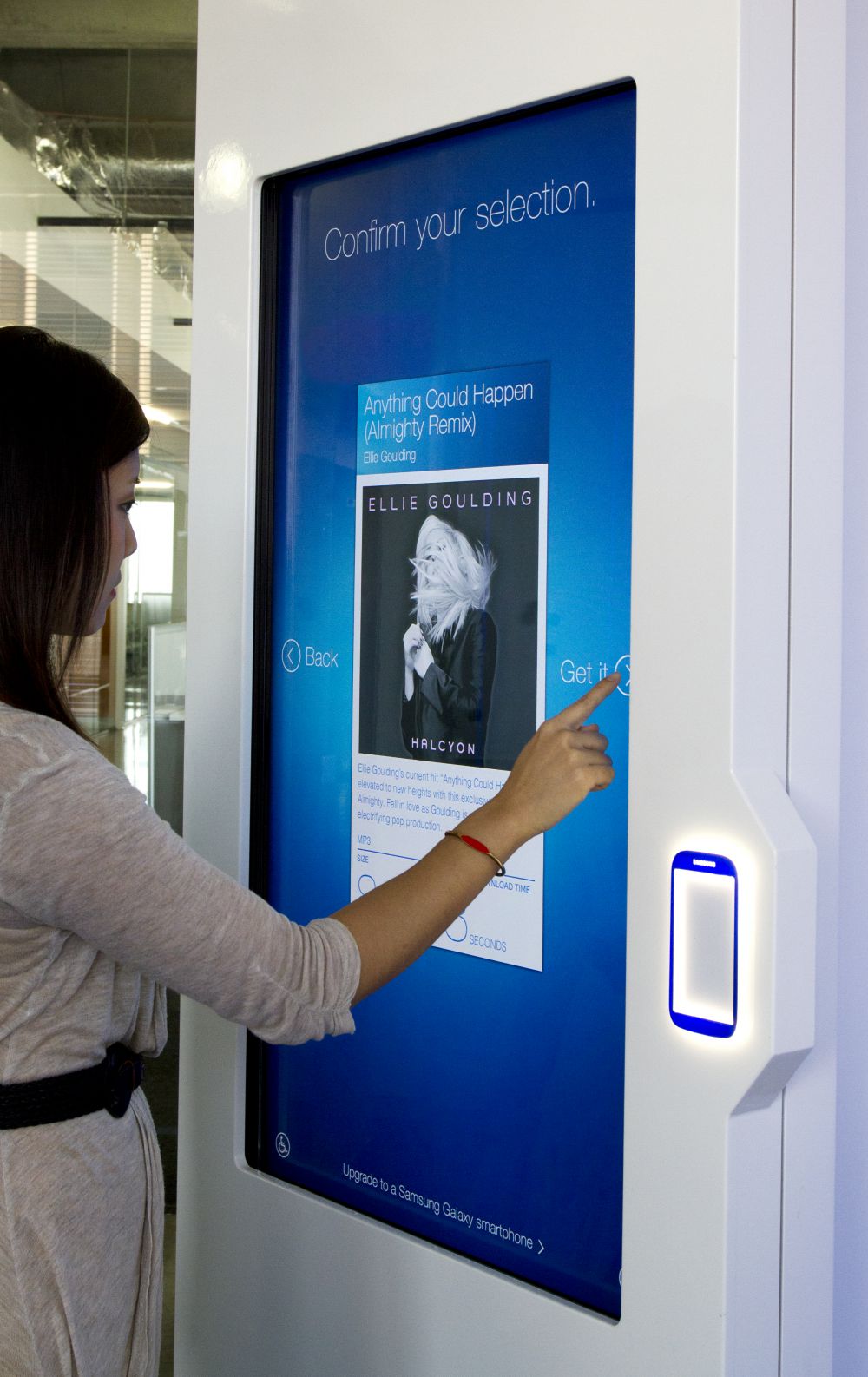 User selecting content to download via the Samsung NFC kiosk screen