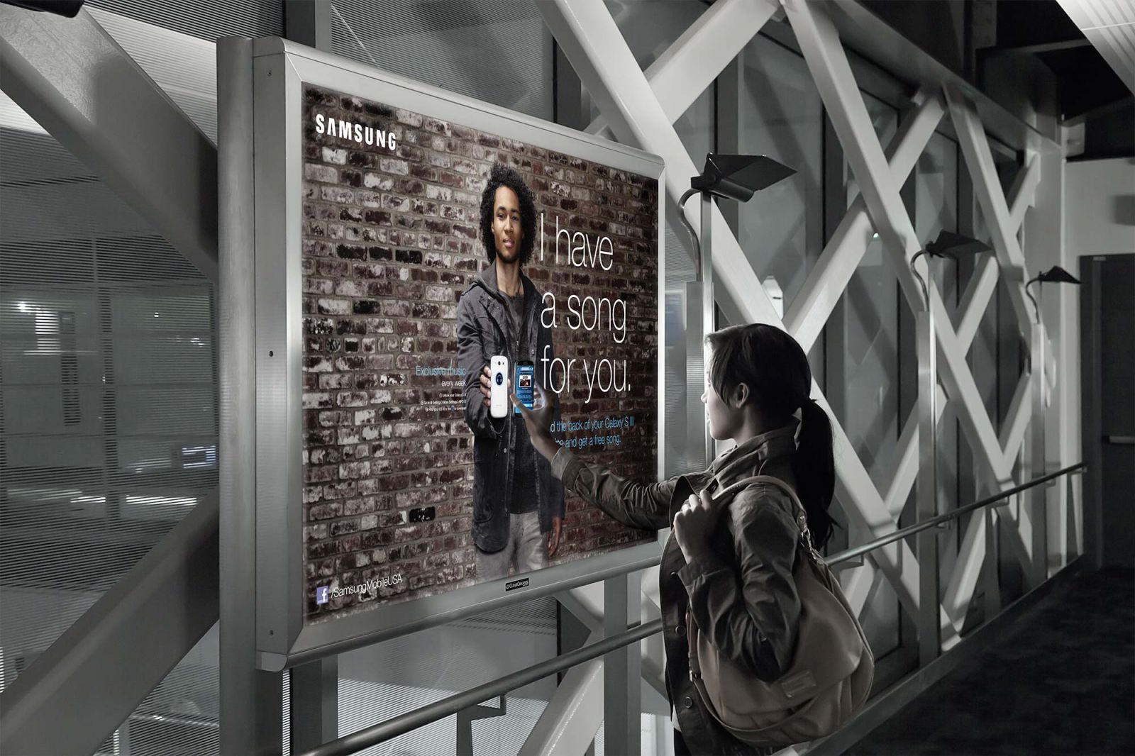 Woman interacting with Samsung NFC powered poster using her phone