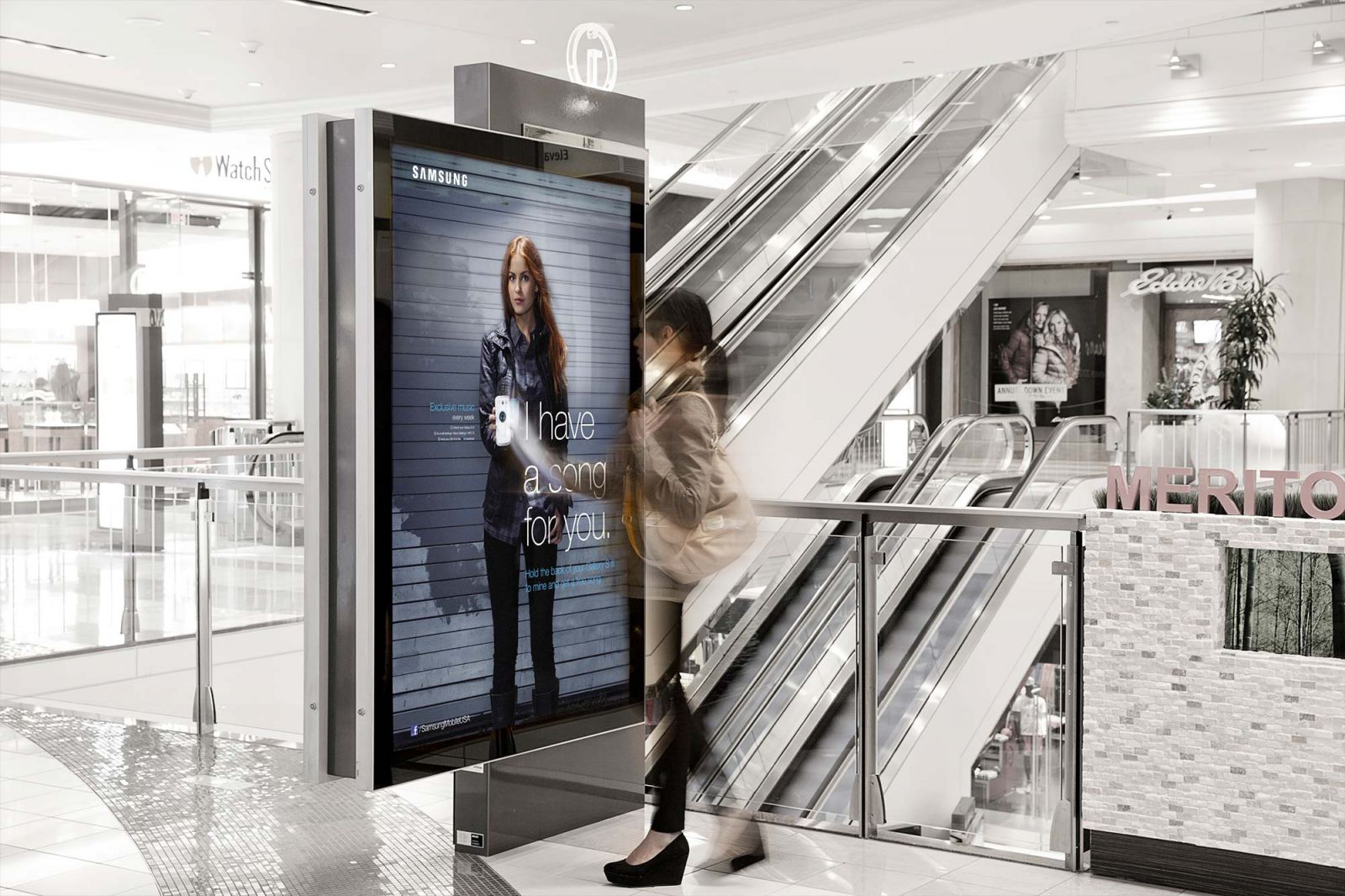 Woman interacting with Samsung NFC poster in a mall