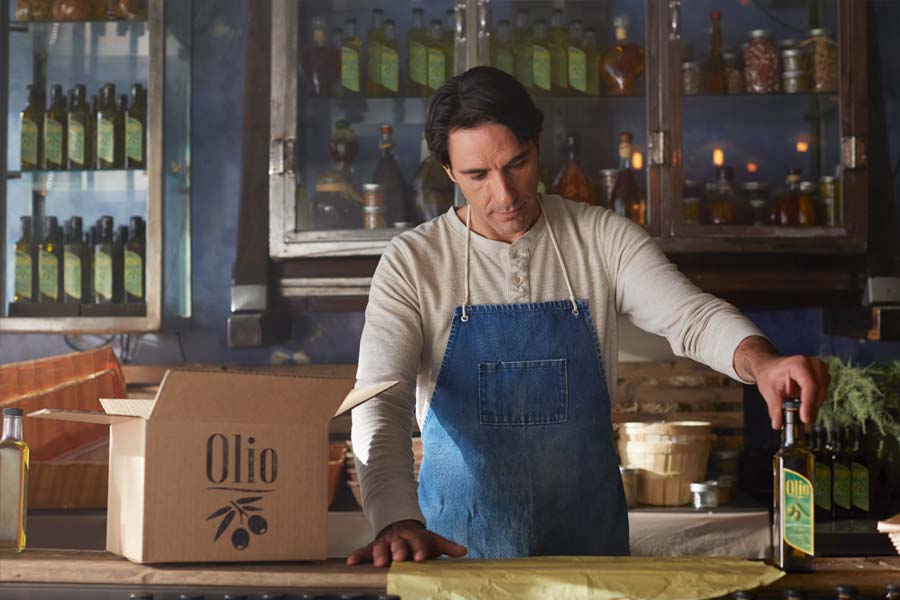 olive oil maker preparing to pack product for shipping
