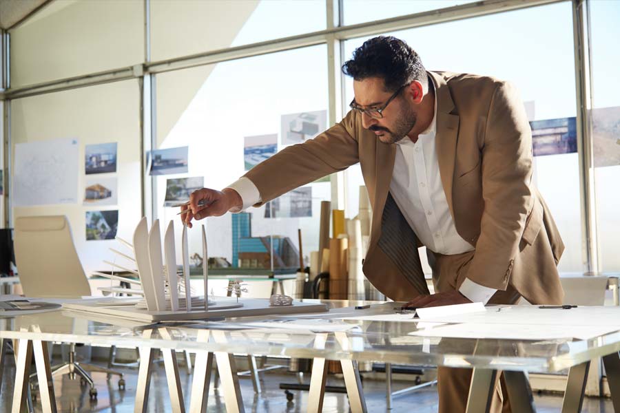 architect inspecting architectural model