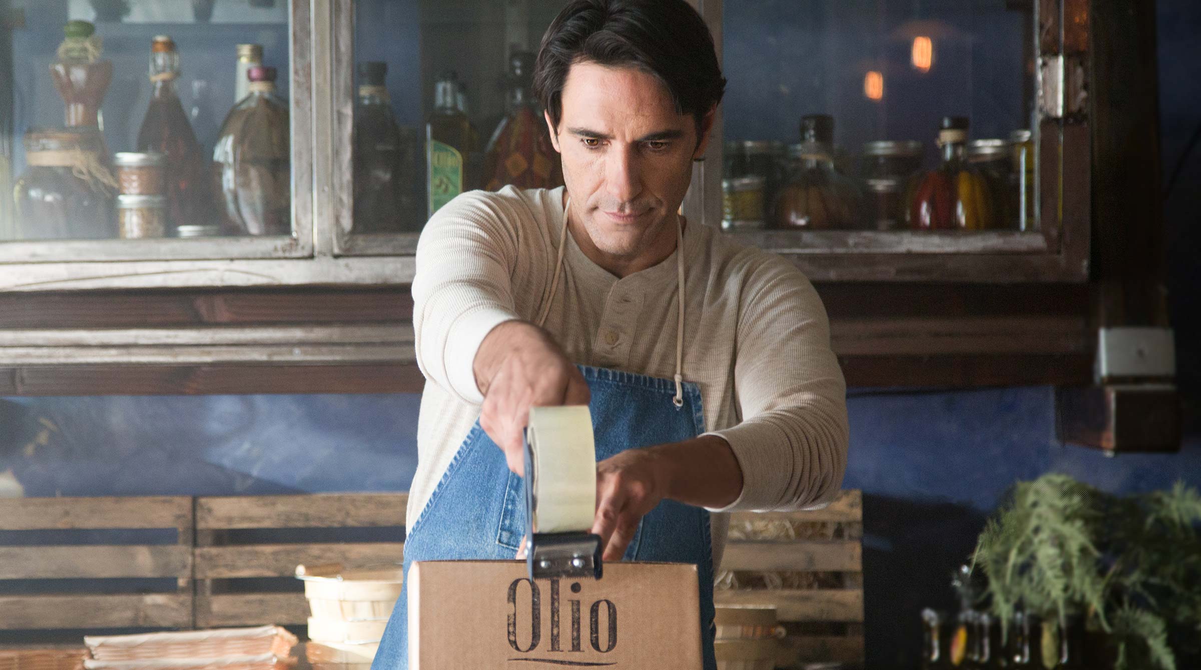 UPS brand imagery - olive oil maker packing a shipping box